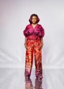 Model in the ANUPAM magenta flared waist organza top with puff sleeves