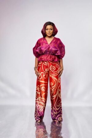 Model in the ANUPAM magenta flared waist organza top with puff sleeves