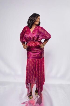 Model in the ANUPAM magenta flared waist organza top with puff sleeves
