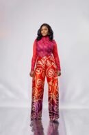 Model in the FARIDA wide-leg silk trousers in a red, orange and purple swirl print