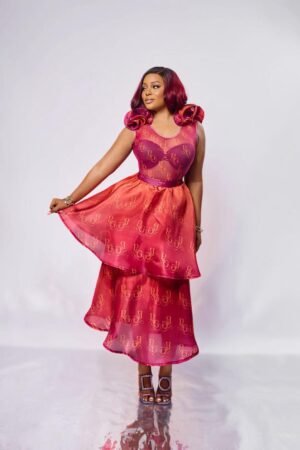 Model in the MARO pink mesh bodysuit with organza ruffle shoulders, styled with the MANDAR skirt