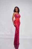 Model in the SELA red and pink tassel strap mesh dress with the Plum & Grey monogram